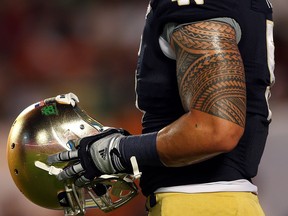 Manti Te'o of the Notre Dame Fighting Irish warms up prior to playing against the Alabama Crimson Tide in the BCS National Championship game at Sun Life Stadium in Miami Gardens. (Photo by Mike Ehrmann/Getty Images)