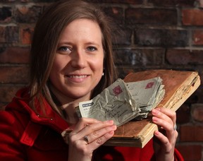 Wearing her grandmother's ring on her right hand, Carly Butler holds a book of telegrams and a stack of letters written by her grandmother and grandfather during WWII December 19, 2012. (NICK BRANCACCIO/The Windsor Star)