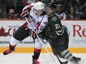 Windsor's Ben Johnson, left, is checked by London's Tyler Ferry at the WFCU Centre earlier this year. (DAN JANISSE/The Windsor Star)