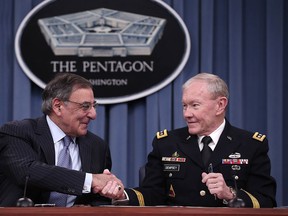 U.S. Defense Secretary Leon Panetta (L) and Chairman of the Joint Chiefs of Staff General Martin Dempsey shake hands after signing orders that will lift a ban on women in combat positions within the U.S. military at the Pentagon January 24, 2013 in Arlington, Virginia. The U.S. Army and the Marine Corps will present plans to open most combat occupations to women by May 15. (Photo by Win McNamee/Getty Images)