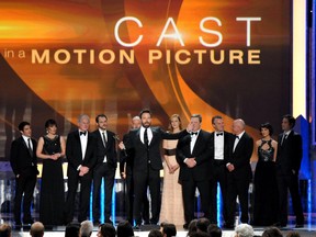 Ben Affleck, center, and the cast of argo accept the award for outstanding cast in a motion picture for “Argo” at the 19th Annual Screen Actors Guild Awards at the Shrine Auditorium in Los Angeles on Sunday Jan. 27, 2013. (Photo by John Shearer/Invision/AP)