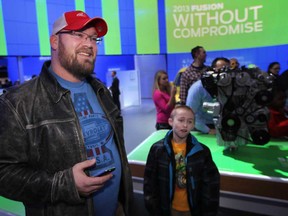 Barney Blackschear, left, and his son, Tristan Blackschear, 9, from White Lake, Mich., visit the North American International Auto Show at Cobo Hall in Detroit, Sunday, January 20, 2013.  (DAX MELMER / The Windsor Star)