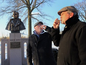 Alan Ferguson and Kit McEvoy celebrate Robert Burns day at the Robert Burns monument at Jackson Park in Windsor, Ontario. (JASON KRYK/The Windsor Star)