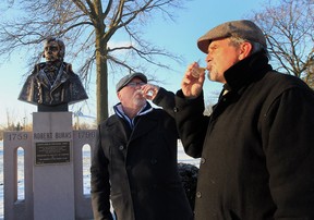 Alan Ferguson and Kit McEvoy celebrate Robert Burns day at the Robert Burns monument at Jackson Park in Windsor, Ontario. (JASON KRYK/The Windsor Star)