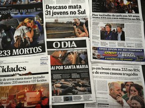 The front pages of the main Brazilian newspapers in a newsstand in Rio de Janeiro, Brazil, on January 28, 2013 have images and headlines related to the tragedy that occured on the eve in the southern city of Santa Maria, when a blaze in a disco killed 233 youngsters. A massive blaze at a nightclub in Brazil killed more than 230 people and left relatives desperately searching for loved ones as horrific accounts emerged of a tragic rush to escape the inferno. AFP PHOTO/VANDERLEI ALMEIDA