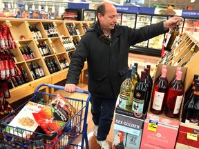 With many choices,  Pat O'Neil looks for a bottle of wine at Meijer Grocery store in Detroit Thursday January 3, 2013. ( NICK BRANCACCIO/The Windsor Star)