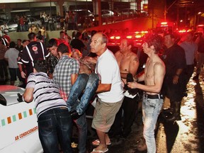 A victim of a fire in a club is carried in Santa Maria city, Rio Grande do Sul state,  Brazil,  early Sunday,  Jan. 27,  2013.  According to police more than 200 died in the devastating nightclub fire in southern Brazil.  Officials say the fire broke out at the Kiss club in the city of Santa Maria while a band was performing. At least 200 people were also injured.  (AP Photo/Deivid Dutra/Agencia Freelancer)