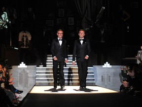 Designers Dean an Dan Caten acknowledge the audience at the end of the Dsquared2 Fall-Winter 2013-2014 Menswear collection on January 15, 2013 during the Men's fashion week in Milan. AFP PHOTO / TIZIANA FABITIZIANA FABI/AFP/Getty Images