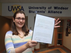Kim Orr, president of the University of Windsor Students' Alliance displays two letters of apology after settling a lawsuit that was filed against two senior members of the student government at the University of Windsor. The lawsuit was filed after two senior members of the student government publicly alleged Orr had pocketed money from a splashy welcome-week concert in the fall that became a money-losing venture.(JASON KRYK/The Windsor Star)