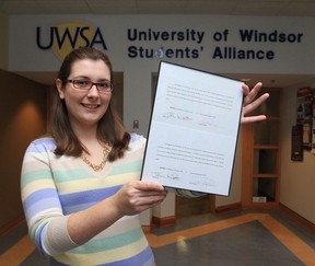 Kim Orr, president of the University of Windsor Students' Alliance displays two letters of apology after settling a lawsuit that was filed against two senior members of the student government at the University of Windsor. The lawsuit was filed after two senior members of the student government publicly alleged Orr had pocketed money from a splashy welcome-week concert in the fall that became a money-losing venture.(JASON KRYK/The Windsor Star)