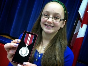 Sarah Lewis,12, holds her Queen's Diamond Jubilee medal at Central Public School on Jan. 21, 2013. (Dax Melmer/The Windsor Star)