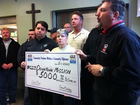 Members of CAW Local 444, including president Dino Chiodo, present a $5,000 cheque to the Downtown Mission on Jan. 21, 2013. (Grace Macaluso/The Windsor Star)