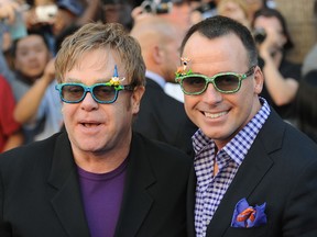 A picture dated January 23, 2011 shows British pop star Elton John (L) arriving with his partner David Furnish at the world premiere of the animated Disney comedy adventure â€œGnomeo & Juliet," at the El Capitan Theatre in Hollywood, California. The couple confirmed on January 16, 2012 that they have become parents to their son Elijah Joseph Daniel Furnish-John, who was born in Los Angeles on January 11, 2013 to a surrogate mother. AFP PHOTO / ROBYN BECKROBYN BECK/