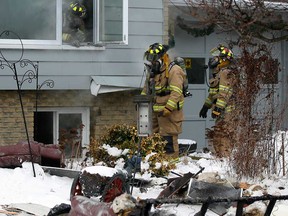 Tecumseh firefighters on the scene of a house fire at 397 Manning Rd. in Tecumseh, Ont. which caused $350,000-$400,000 damage to the single family home January 1, 2013. ( NICK BRANCACCIO/The Windsor Star)