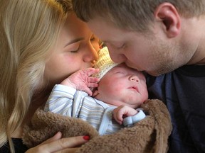 Kyle Labelle and Robby Fransen kiss their newborn son Bryan Labelle, Tuesday, Jan. 1, 2013, at the Windsor Regional Hospital. Born at 12.29 a.m. he was the first local baby of 2013. (DAN JANISSE/The Windsor Star)