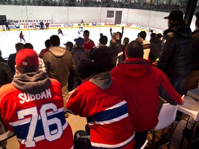 Fans gather to watch the Montreal Canadiens during their first day of training camp in Brossard, Que., on Sunday, January 13, 2013. THE CANADIAN PRESS/Paul Chiasson