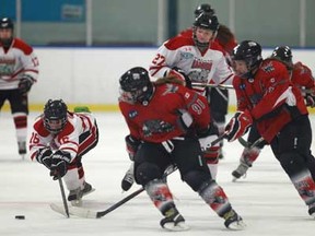 Leaside's Emily McMahon, centre-left, battles for the puck with teammate Miranda Vonhanke, centre-back, and Southwest's Krystin Lawrence, centre, and Erinn Noseworthy as the Southwest Wildcats host the Leaside Wildcats at Forest Glade Arena, Sunday, January 6, 2013.  (DAX MELMER / The Windsor Star)