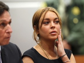 Troubled actress Lindsay Lohan appears in court for a pretrial hearing with her new lawyer Mark Heller before Judge Stephanie Sautner at the Airport Branch Courthouse of Los Angeles Superior Court on January 30, 2013 in Los Angeles, California. Lohan is charged with three misdemeanor counts involving a car crash - willfully resisting, obstructing or delaying an officer, providing false information to an officer and reckless driving. She is also accused of violating her probation in a misdemeanor jewelry theft case. (Photo by David McNew/Getty Images)