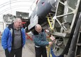 John Robinson, right, president of the Canadian Historical Aircraft Association, and Brad Saunders, project director for the Lancaster restoration project, check out a wing section of Windsor's FM 212 Lancaster Bomber Monday, Jan. 14, 2013, in Windsor, Ont. Volunteers are donating hundreds of hours bringing the plane back to life.  (DAN JANISSE/The Windsor Star