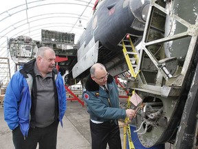 John Robinson, right, president of the Canadian Historical Aircraft Association, and Brad Saunders, project director for the Lancaster restoration project, check out a wing section of Windsor's FM 212 Lancaster Bomber Monday, Jan. 14, 2013, in Windsor, Ont. Volunteers are donating hundreds of hours bringing the plane back to life.  (DAN JANISSE/The Windsor Star