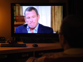 A photo illustration shows a man watching a TV showing disgraced cycling star Lance Armstrong being interviewed by Oprah Winfrey on January 17, 2013 in Kensington, Maryland. Armstrong said in the interview that he was "sorry" for taking performance-enhancing drugs during his career and that it was a mistake. AFP PHOTO/Mandel NGANMANDEL NGAN/AFP/Getty Images