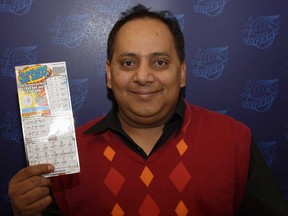 This undated photo provided by the Illinois Lottery shows Urooj Khan, 46, of Chicago's West Rogers Park neighbourhood, posing with a winning lottery ticket. The Cook County medical examiner said Monday, Jan. 7, 2013, that Khan was fatally poisoned with cyanide July 20, 2012, a day after he collected nearly $425,000 in lottery winnings. (AP Photo/Illinois Lottery)