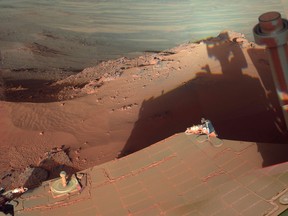 This image provided by NASA shows the late-afternoon shadow cast by the Mars rover Opportunity at Endeavour Crater. The six-wheel rover landed on Mars in January 2004 and is still going strong. (AP Photo/NASA)
