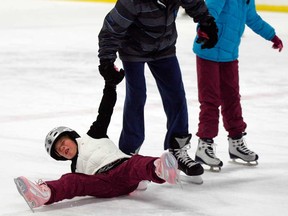 Madalyn Gillis, 7, takes a tumble while skating with Evan Arvic, 14, and sister Sarah Gillis, 9, during New Year's Eve family party at Lanspeary Park December 31, 2012. The event was sponsored by Tim Hortons and AM-800. ( NICK BRANCACCIO/The Windsor Star)