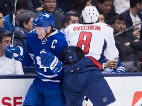 Toronto defencman Dion Phaneuf, left, takes a hit from Washington's Alexander Ovechkin Thursday. (THE CANADIAN PRESS/Nathan Denette)