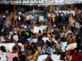 Mock hangmen's nooses hang during a protest demanding the death penalty for six men accused of the fatal gang rape of a young woman in New Delhi last month in New Delhi, India, Tuesday, Jan. 29, 2013. Scores of protesters gathered near India's Parliament on Tuesday carrying placards saying: "Give us Justice, Hang the Rapists," and shouted slogans before conducting a mock hanging of the men who are facing trial in a special court in New Delhi. (AP Photo/Altaf Qadri)