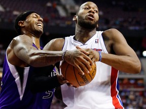 Sacramento Kings forward James Johnson, left, tries to steal the ball away from Detroit Pistons center Greg Monroe, right, in the second half of an NBA basketball game, Tuesday, Jan. 1, 2013, in Auburn Hills, Mich. Monroe scored 18 points and pulled in 11 rebounds in a 103-97 win. (AP Photo/Duane Burleson)