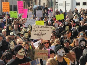 People protest at the Jefferson County Courthouse in Steubenville, Ohio, Saturday, Jan. 5, 2013. Authorities investigating rape accusations against two high school football players in eastern Ohio launched a website Saturday as interest in the case balloons, an extraordinary step designed to combat the misperception "that the football team runs the city," the city manager said. (AP Photo/The Plain Dealer, Thomas Ondrey)