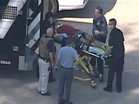 In this frame grab provided by KPRC Houston, an unidentified person is transported by emergency personnel at Lone Star College Tuesday, Jan. 22, 2013, in Houston, where law enforcement officials say the community college is on lockdown amid reports of a shooter on campus. (AP / KPRC TV)