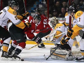Sarnia's Daniel Nikandrov, left, crosschecks Windsor's Adam Bateman in front of Sarnia goalie, JP Anderson while Sarnia's Joshua Chapman looks on in Windsor's 5-4 victory against the visiting Sarnia Sting at the WFCU Centre, Sunday, January 20, 2013.  (DAX MELMER / The Windsor Star)