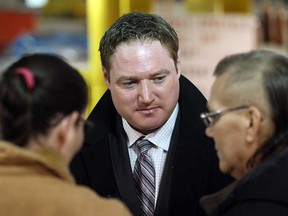 Essex MPP Taras Natyshak walks through Market Square speaking with area residents like Tammy and Tom Lockhart  about challenges faced by job creators in Windsor, Ont., January 22, 2013. (NICK BRANCACCIO/The Windsor Star)