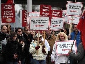 In this file photo, Mario Spagnuolo, right, first vice-president of the Greater Essex Elementary Teachers' Federation of Ontario, speaks with education workers as they hold a protest outside the Caboto Club where the Liberal's delegate election meeting was being held, Sunday, January 13, 2013.  (DAX MELMER / The Windsor Star)