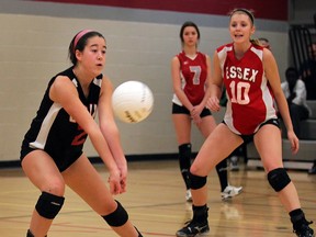 Essex Raiders Briallen Pettit, left, tries to controls a hard serve in front of teammate Emily McCloskey, right, and Brennan line judge Sonia Bobek in game against Brennan Cardinals in high school volleyball action from Brennan gym Monday January 14, 2013. (NICK BRANCACCIO/The Windsor Star)