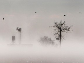 Fog gathers over Lake Winnebago during a stretch of bitter cold weather Tuesday Jan. 22, 2013, in Menasha, Wis. The upper Midwest is in a third straight day of bitter cold temperatures. (AP Photo/The Post-Crescent, William Glasheen )