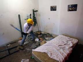 In this Dec. 27, 2012 photo visitor Savo Duvnjak smashes furniture and other household items during a demolishing session at the Rage Room, in Novi Sad, Serbia. Since it opened in the northern Serbian city of Novi Sad in October, Serbia's Rage Room has drawn much publicity in the Balkan country where two decades or wars, crisis and economic hardship have driven many over the edge. Inspired by a similar Anger Room business in Dallas, Texas, Serbia's version was set up by two teens who saw the U.S. room idea on the Internet and figured it could be a good way to earn pocket money. (AP Photo/Darko Vojinovic)