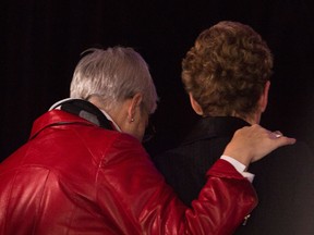 Kathleen Wynne, right, and her partner Jane Rounthwaite leave the stage after celebrating her victory and being the first women Premier at the Ontario Liberal Leadership convention in Toronto on Saturday, January 26, 2013. THE CANADIAN PRESS/Nathan Denette