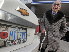 Second World War veteran Harry Sigal poses Thursday, Jan. 10, 2013, next to his car in downtown Windsor, Ont. He is upset after getting a city of Windsor parking ticket recently. A municipal policy allows war veterans with proper identifying licence plates to park for free at any city meter.  (DAN JANISSE/The Windsor Star)