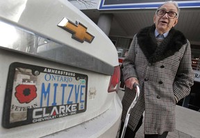 Second World War veteran Harry Sigal poses Thursday, Jan. 10, 2013, next to his car in downtown Windsor, Ont. He is upset after getting a city of Windsor parking ticket recently. A municipal policy allows war veterans with proper identifying licence plates to park for free at any city meter.  (DAN JANISSE/The Windsor Star)