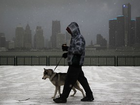 Keenan Thomas walks with his dog Taz, a nine-year old Siberian Husky, in one hand and a Timmies coffee in the other as he walks along Windsor's riverfront on a cold January morning, Monday, January 21, 2013. (DAX MELMER / The Windsor Star)