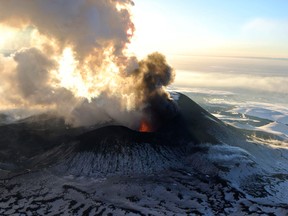 In this photo taken on Sunday, Jan. 6, 2013, Plosky Tolbachnik volcano erupts in Russia’s Far Eastern Kamchatka Peninsula. A Russian volcano which started erupting last week has continued to spew ash and smoke into the air. The Plosky Tolbachik volcano, in the Kamchatka Peninsula, last erupted in 1976. (AP Photo/Alexander Petrov)