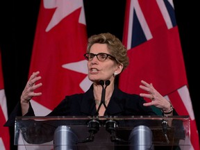 Kathleen Wynne gestures at her first press conference as leader of the Ontario Liberal Party, Jan. 27, 2013. (Nathan Denette / Canadian Press)