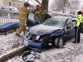 Windsor Police, Windsor firefighters and Essex-Windsor EMS paramedics at the scene of a three-car collision on Campbell Avenue, south of Grove Avenue Friday January 25, 2013. Road conditions were slippery at the time of the collision involving a Pontiac Sunfire, Pontiac Grand Am and a Cadillac. (NICK BRANCACCIO/The Windsor Star)