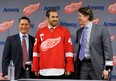 Detroit Red Wings general manager Ken Holland, left, and head coach Mike Babcock, right, stand with Henrik Zetterberg during an NHL hockey news conference announcing Zetterberg's appointment as team captain at Compuware Arena in Plymouth, Mich., Tuesday, Jan. 15, 2013. Zetterberg replaces retired defenseman Nicklas Lidstrom. (AP Photo/Detroit News, David Guralnick)