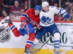 Montreal rookie Alex Galchenyuk, left, is checked by Toronto's Michael Kostka Saturday at the Bell Centre in Montreal. (Photo by Richard Wolowicz/Getty Images)