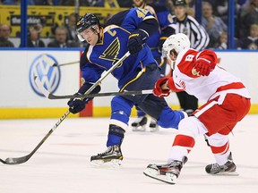 Blues captain David Backes, left, takes a shot in front of Detroit's Justin Abdelkader at the Scottrade Center in St. Louis. (Photo by Dilip Vishwanat/Getty Images)