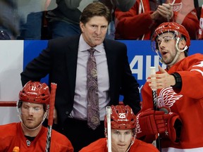 Detroit's Drew Miller, right, talks to coach Mike Babcock during the second period of Tuesday's home opener against the Dallas Stars Tuesday. (AP Photo/Carlos Osorio)